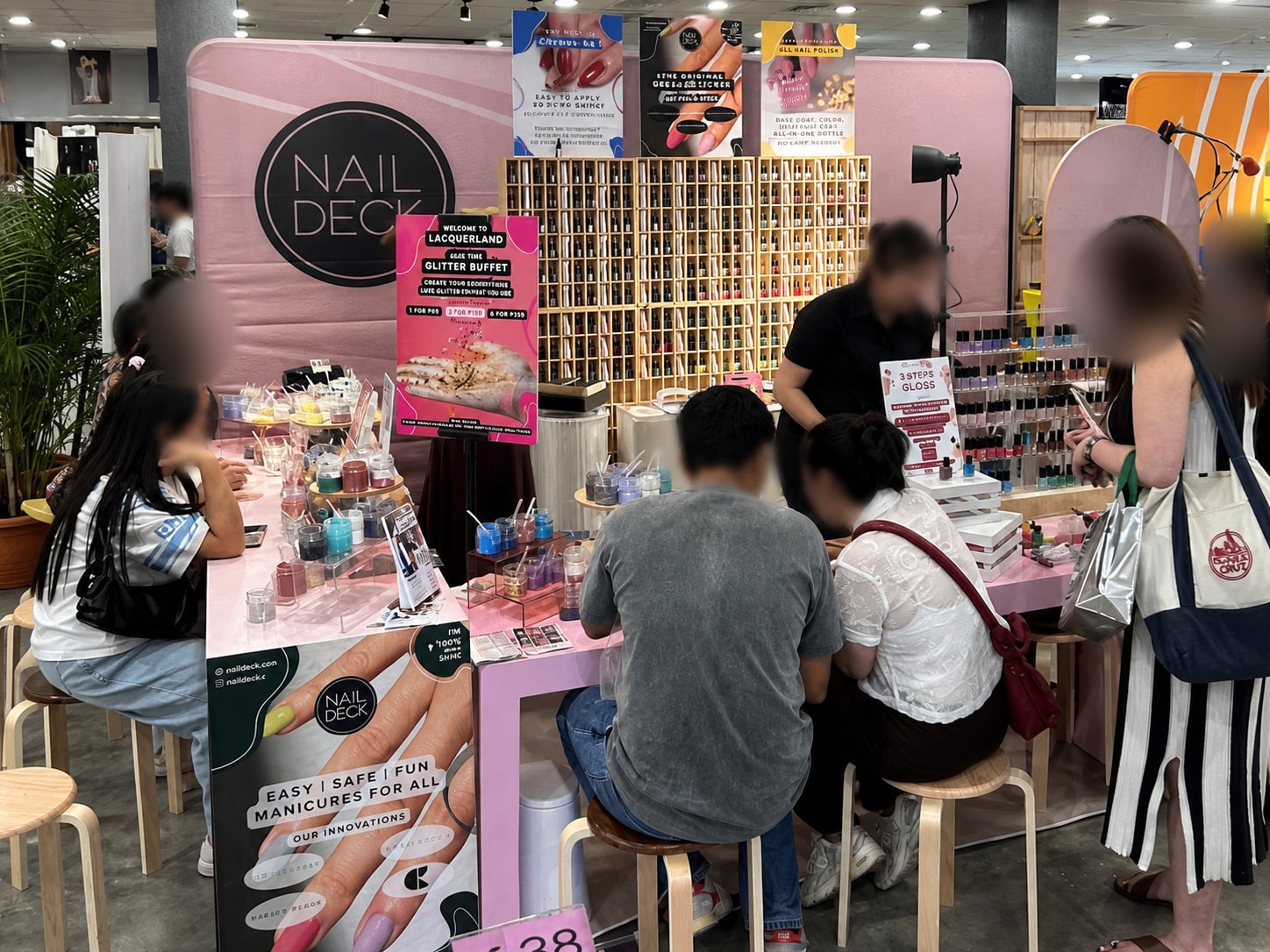 Nail Deck branded tension fabric backdrop installed behind its event booth
