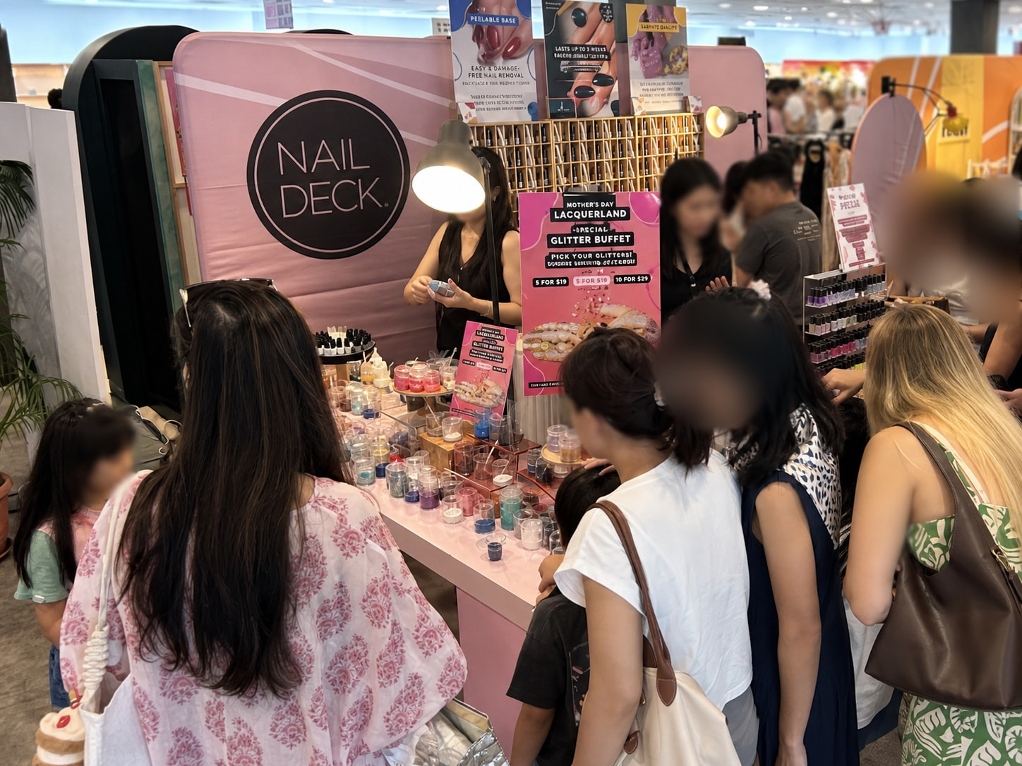 Closer view of the Nail Deck event backdrop and branded booth setup